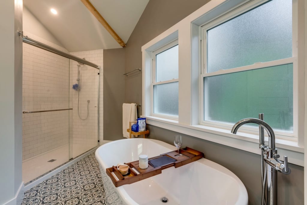 Newly remodeled bathroom with a large tub, walk-in shower, and patterned tile floor