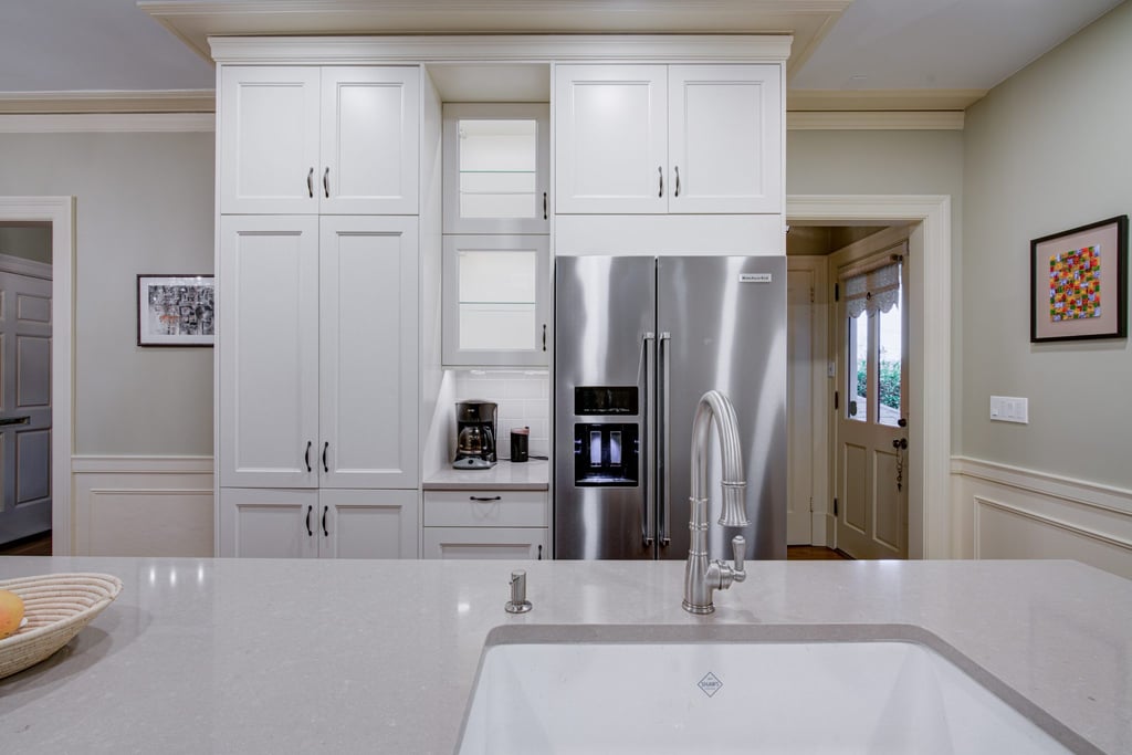 Newly remodeled kitchen with white cabinets and an island