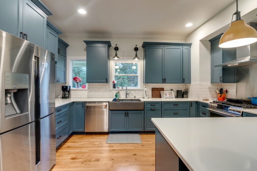 kitchen remodel with bold blue cabinets and white countertops
